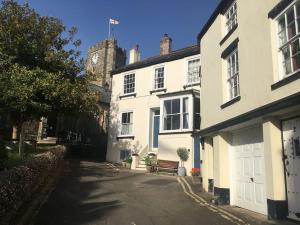 a white building with a clock tower in the background at Studio at Church House in Bideford