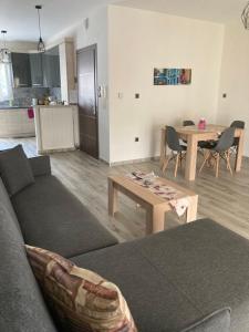 a living room with a couch and a table at Classic and Chic in Volos