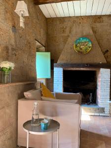 a room with a couch and a table with a fireplace at Civita Secret Lodge in Lubriano