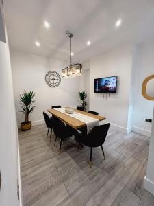 a dining room with a table and chairs at Stylish Stay Near The Stadium Walk To The Action in Liverpool