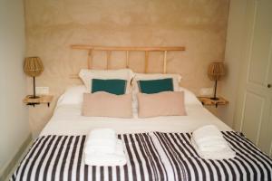 a bedroom with a large bed with two pillows at Cathedral Sevilla Views in Seville