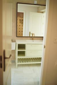 a bathroom with a sink and a mirror at Cathedral Sevilla Views in Seville +34 photos