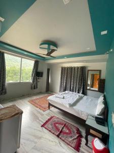 a bedroom with a large bed and a blue ceiling at Pushkar Heritage in Pushkar