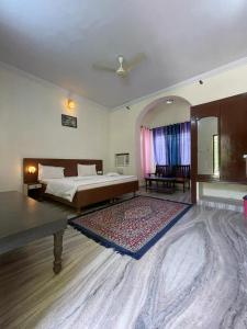 a bedroom with a bed and a large rug at Pushkar Heritage in Pushkar