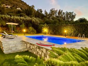 a swimming pool in a yard with a landscaping at Relaxing Villa Cefalù - Private Pool & Beach Walk by flAle's in Cefalù