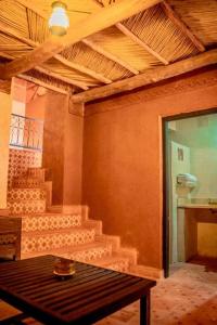 a room with stairs and a table with a table sidx sidx sidx at Ouednoujoum Ecolodge & Spa in Ouarzazate