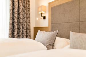 Voodi või voodid majutusasutuse Garni Hotel Am Meilenstein toas