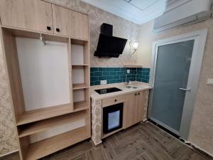 a small kitchen with a sink and a tv at Lords Mansion in Istanbul