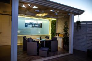 an outdoor dining area with a table and chairs at OPERAPRIMASUITE in Messina