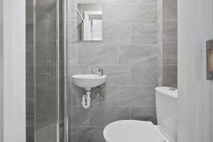 a bathroom with a toilet and a sink at Private Spacious En-suite room in London