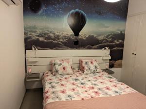 a bedroom with a bed with a balloon mural at Beautiful apartment near beach in Larnaca in Scala