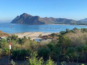 a view of a beach with boats in the water at Ocean Surf Villa in Maluk
