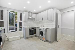 a kitchen with a washer and dryer in it at Private Spacious En-suite room in London