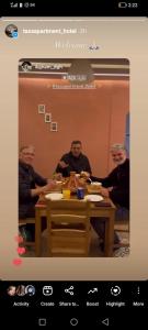 a picture of three men sitting at a table at Taza Organic Garden with view park and restaurant in Taza