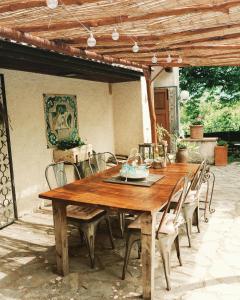 a wooden table and chairs on a patio at La Colombaia Amiata in Arcidosso