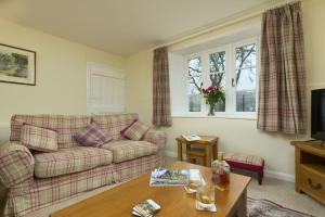 a living room with a couch and a table at 2 Lower Spire in Dulverton