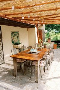 a wooden table and chairs on a patio at La Colombaia Amiata in Arcidosso