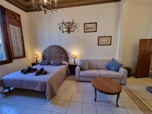 a living room with a bed and a couch at B&B Firenze 400 in Florence