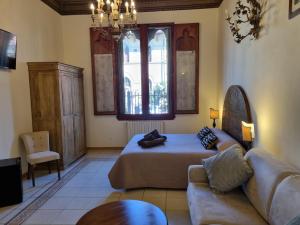 a living room with a bed and a couch at B&B Firenze 400 in Florence
