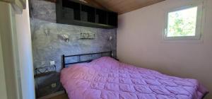 a bedroom with a pink bed and a window at Le Verdoyant in Thenon +51 photos