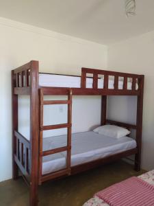 two bunk beds in a room with a ladder at Chalés Rosados in Serra de São Bento +28 photos