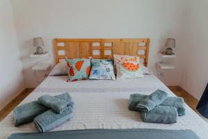 a bedroom with a bed with pillows on it at Lemon Tree Rooms in Barano d'Ischia