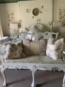 a white bed with pillows on it in a room at The Suites At Ty Anne in Beaumaris