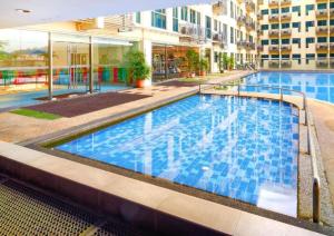 a swimming pool in the middle of a building at Deluxe Twin Room AYS in Kota Kinabalu