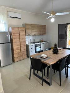 a kitchen with a table and chairs and a refrigerator at Villa Mariuccia in Siracusa