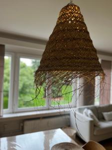 a chandelier hanging over a table in a living room at Cosy Louvrex -Liège Francorchamps in Liège