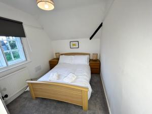 a small bedroom with a bed in the corner at Down Ampney cottage in Down Ampney