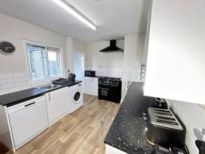 a kitchen with a washer and dryer in it at Down Ampney cottage in Down Ampney