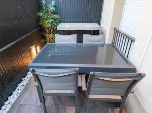 a blue table and two chairs on a balcony at Le splend'id à 10min de Disneyland in Chessy +27 photos