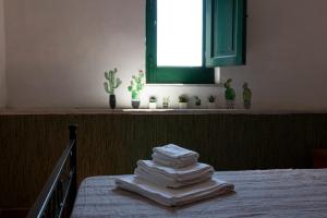 einen Stapel Handtücher auf dem Bett in der Unterkunft Vista da Re in Aci Castello
