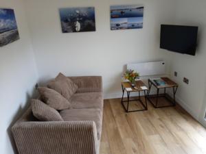 a living room with a couch and a table at theoldgarage in Chichester