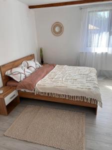 a bedroom with a bed with a rug and a window at Ds Beauty Center in Drăgăşani