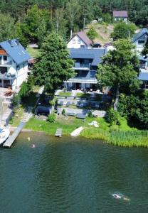 an aerial view of a lake with houses and trees at Weranda in Wdzydze Kiszewskie