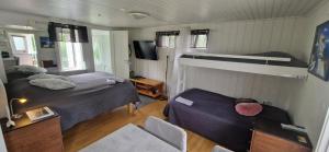 a bedroom with two beds and a bunk bed at Humlebo in Åsa