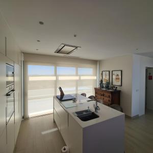 a kitchen with a sink and a counter top at The Panoramic Penthouse in Orihuela