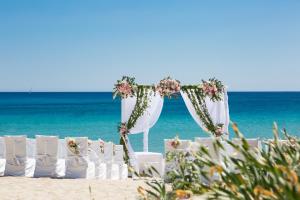 a set up for a wedding on the beach at Cormoran Hotel in Villasimius