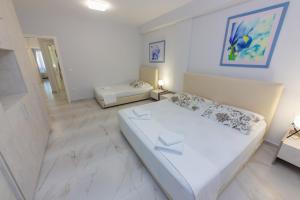 a large white room with a bed and a couch at Luxury Vila 3 in Vlorë +19 photos