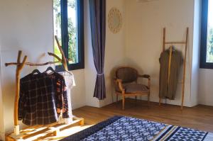 a room with a table and a chair and a window at Les Tanalis - Chambres d'hôtes & Gîte in Gurs