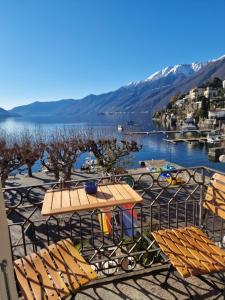 eine Gruppe Stühle und einen Tisch mit Seeblick in der Unterkunft New Elvezia in Ascona