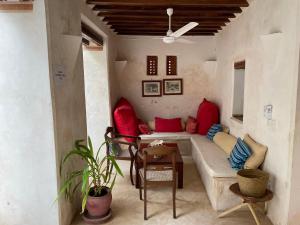 a living room with a couch and a table at Authentic Swahili style villa Milele House in Lamu