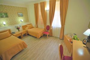 um quarto de hotel com uma cama e um sofá em Sergei Palace Hotel em Jerusalém