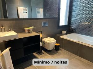 La salle de bains est pourvue d'une baignoire, de toilettes et d'un lavabo. dans l'établissement Casas das Andoreiras, à Moledo