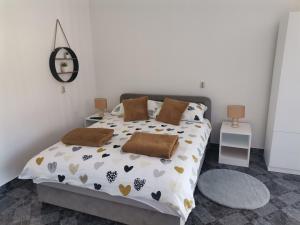 a bedroom with a large bed with hearts on it at Lucija in Gospić