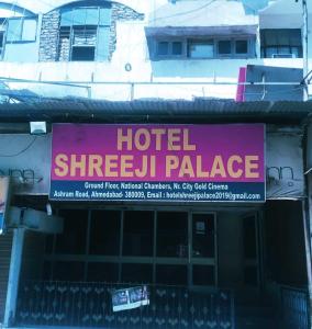 a sign on the side of a building at SPOT ON Hotel Shreeji Palace in Ahmedabad