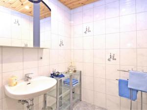 a white bathroom with a sink and a shower at Ferienwohnung RiPa Erzgebirge in Schwarzenberg in Schwarzenberg +16 photos