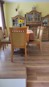 a dining room with a wooden table and chairs at Гери2 in Arbanasi